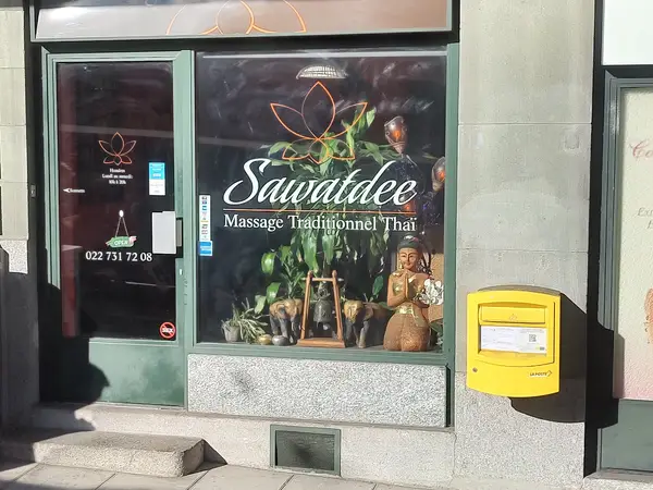 Exterior storefront with Thai massage signage and a yellow mailbox