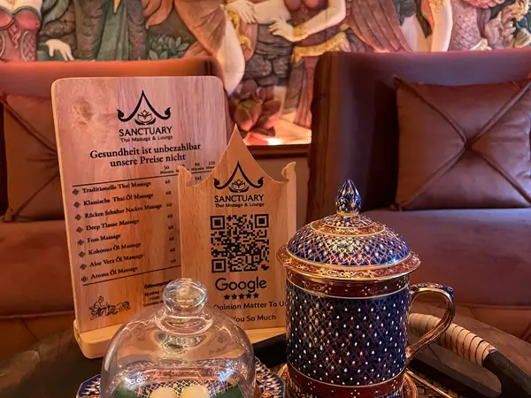 Cozy Thai massage lounge with menu signs, decorative teaware, and cushioned seating