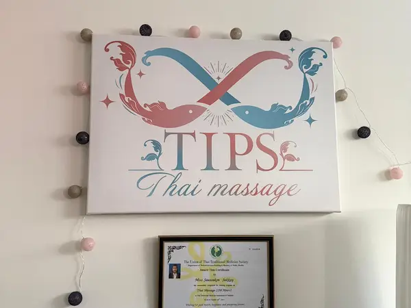 Interior wall sign for Tips Thai Massage with a framed certificate below