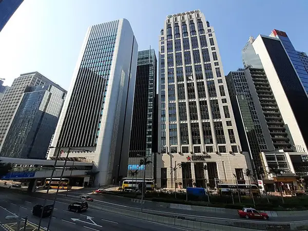 Street view of tall office buildings and traffic under a clear sky