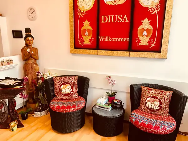 Thai-style waiting area with elephant cushions, Buddha statue, and red welcome sign