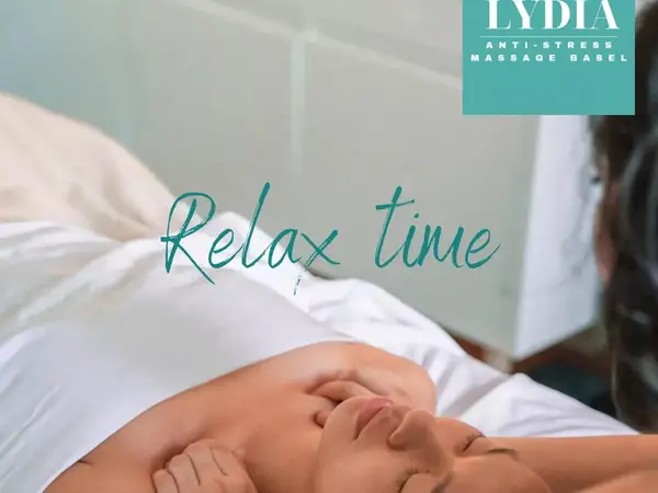 Massage treatment room with a client lying under white sheets, overlaid by “Relax time” text