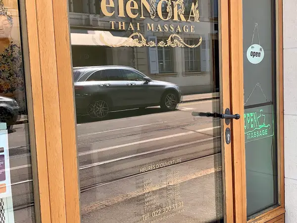 Glass storefront with ELE NORA Thai Massage signage and open signs