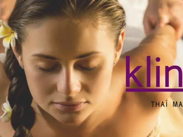 Close-up of a woman receiving a Thai massage, with salon branding overlaid
