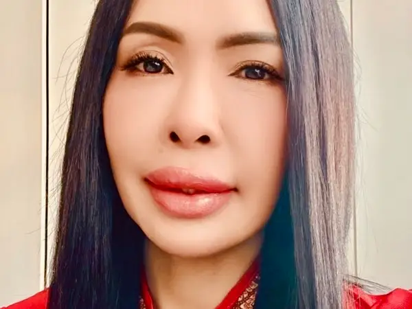Close-up of a woman with long dark hair and a patterned headband indoors
