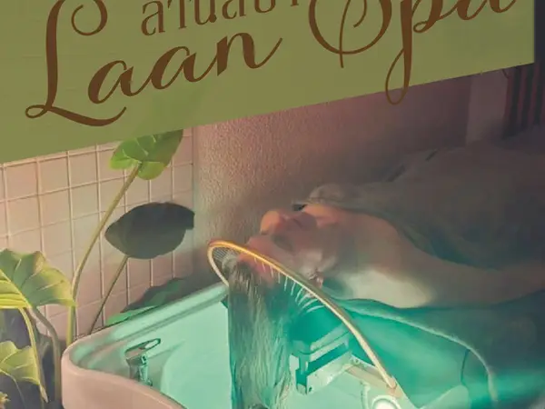 Cozy spa wash basin with a reclining client and soft green lighting